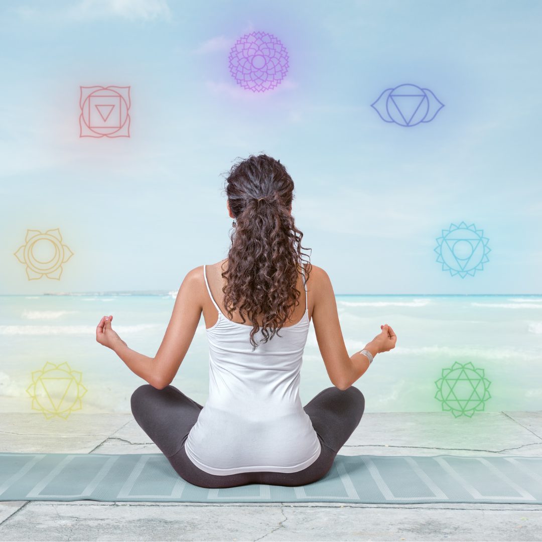 Woman meditating while aligning her chakras