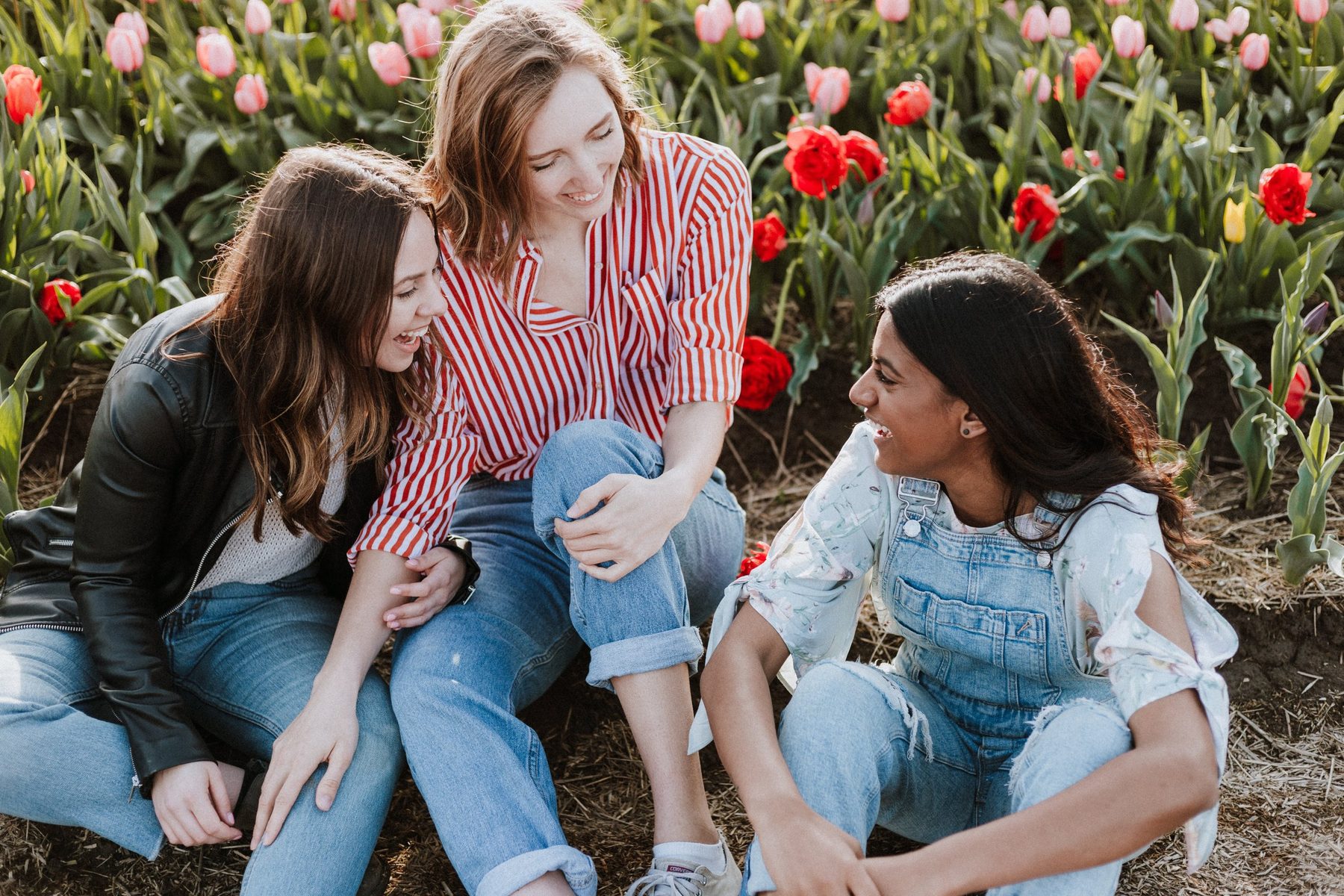 Friends smiling in a flower garden
