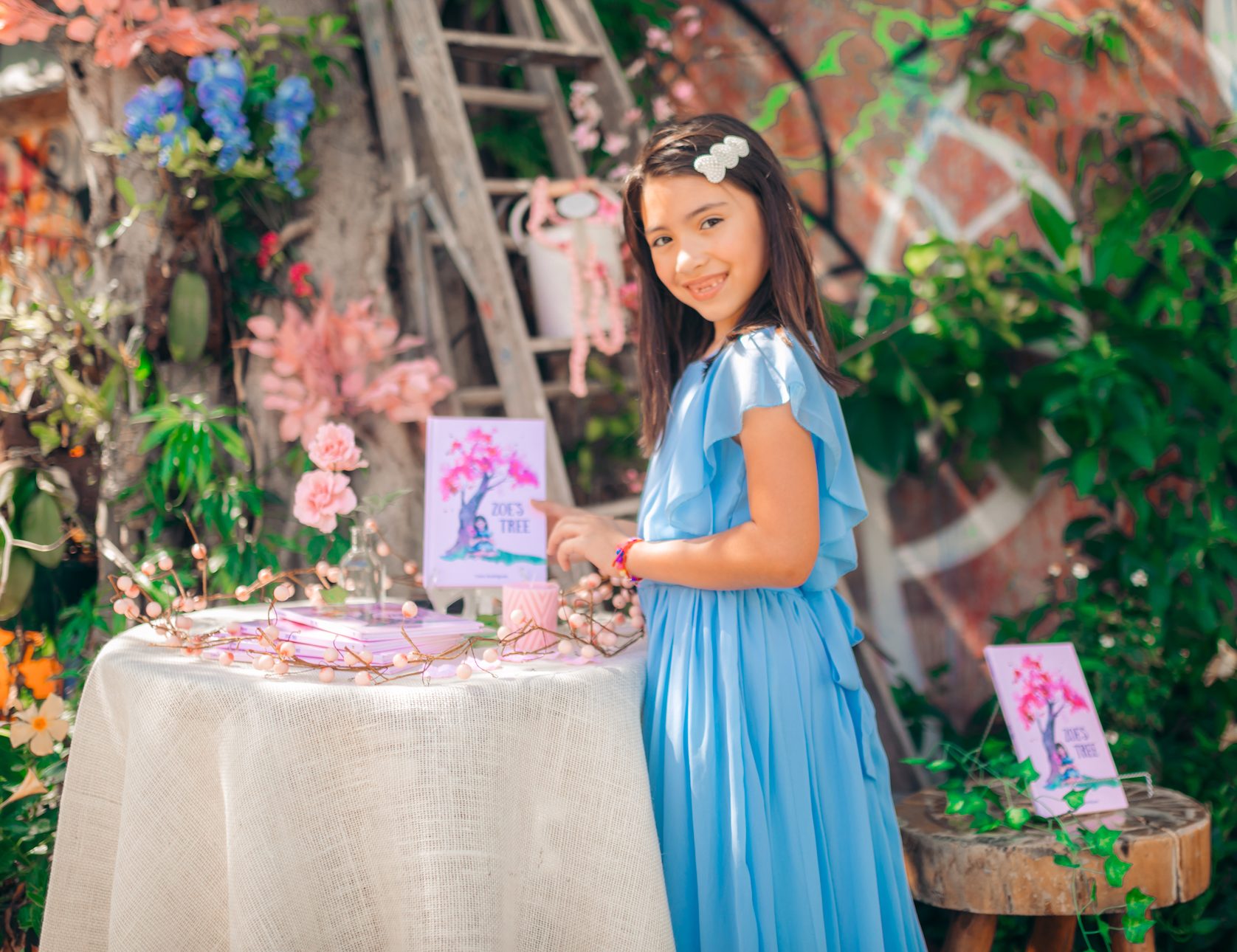 Girl holding a copy of the book Zoe's Tree